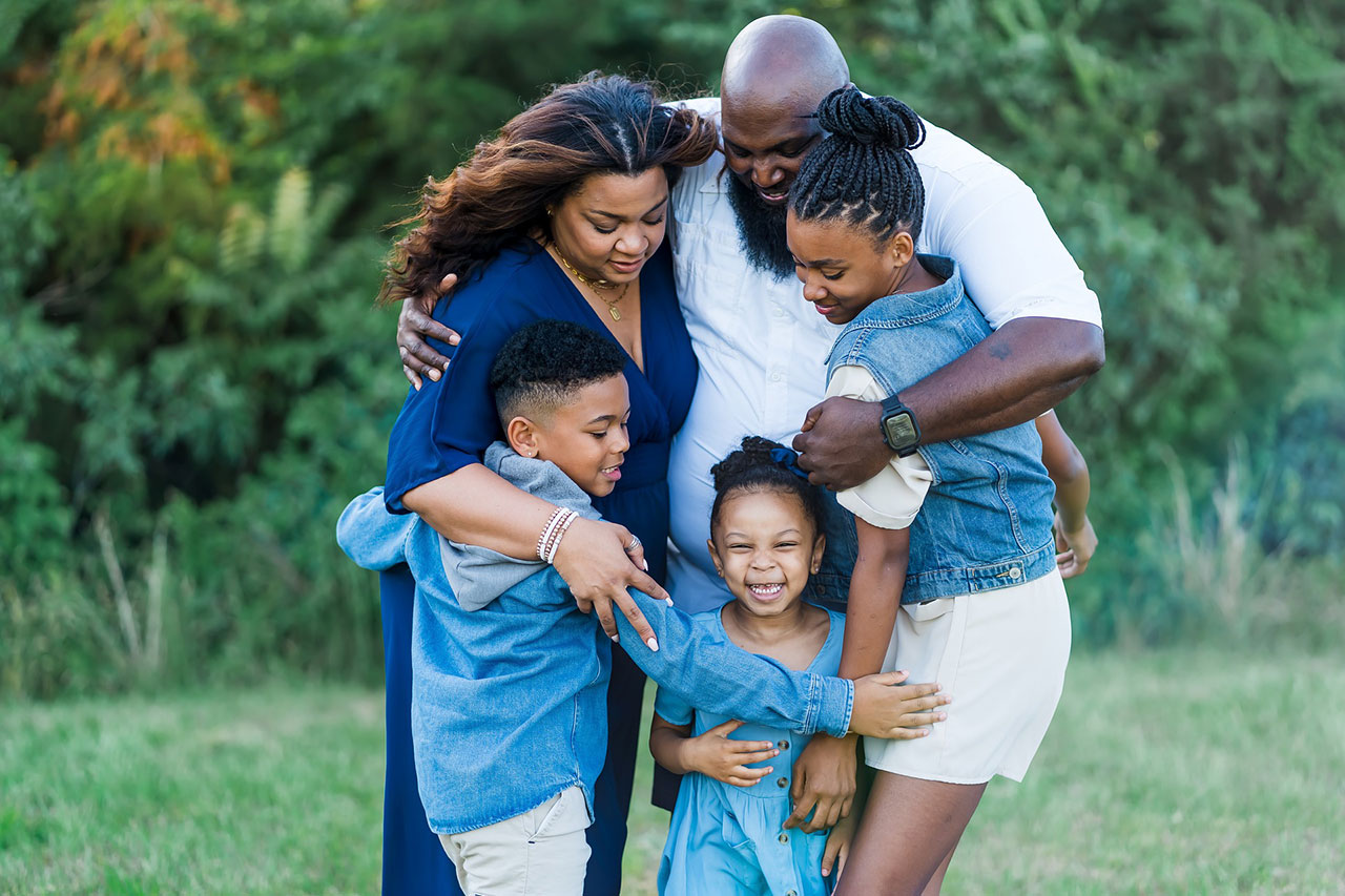 photo of a happy hugging family